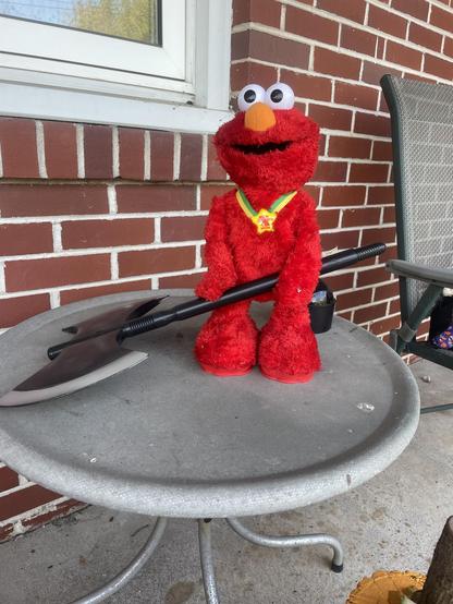 Tickle Me Elmo welding a battle ax
