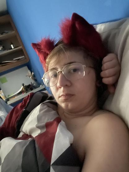 Guy with red wolf ears in bed